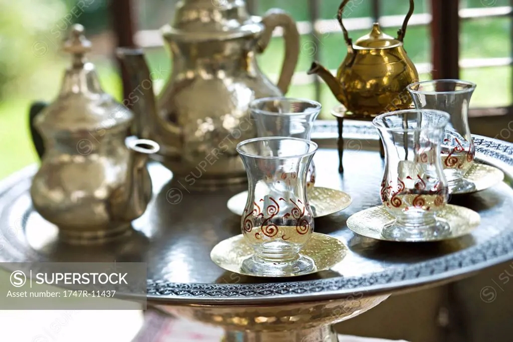 Silver tea tray with teapots and glass tea cups