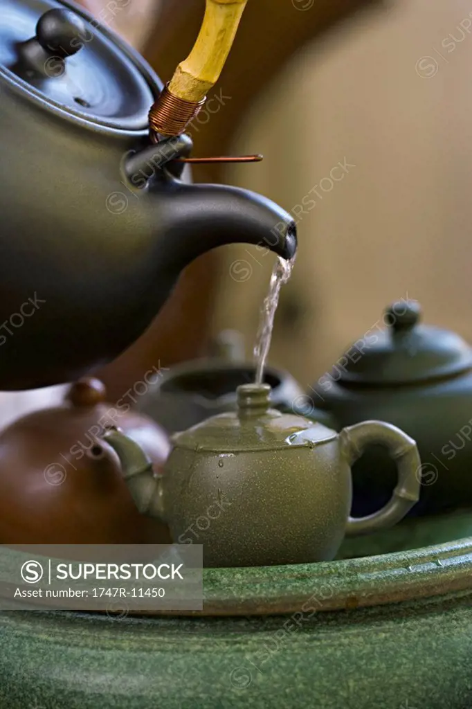 Chinese tea ceremony, warming the brewing pot before steeping the leaves
