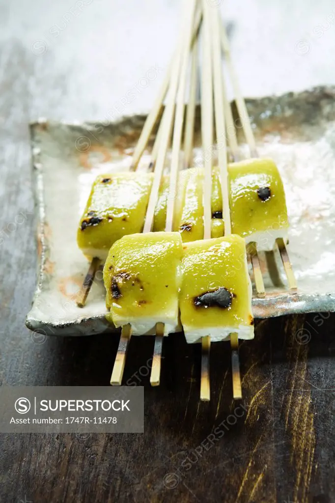 Grilled tofu on wooden skewers topped with miso and sansho