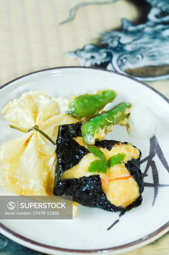 Japanese cuisine, yuba bean curd skin, tofu wrapped in nori and hot pepper tempura on plate