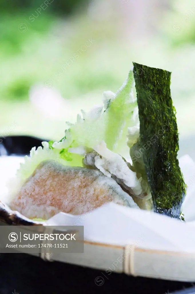 Winter squash and shiso tempura with piece of nori, close-up