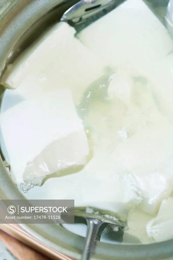 Tofu soaking in water, close-up