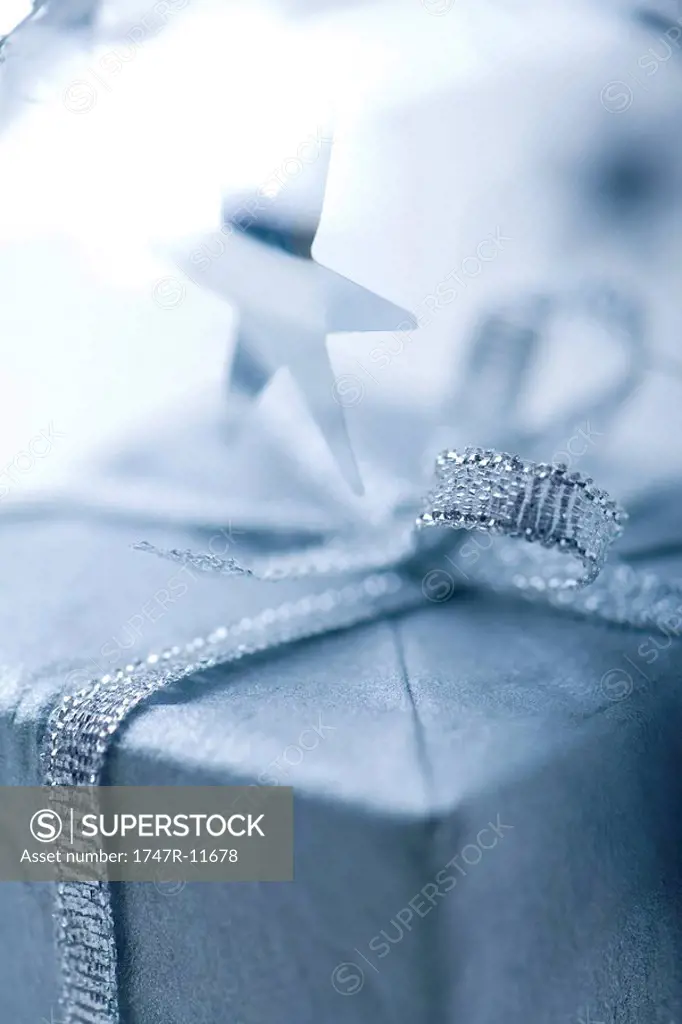 Christmas gift with silver ribbon, close-up