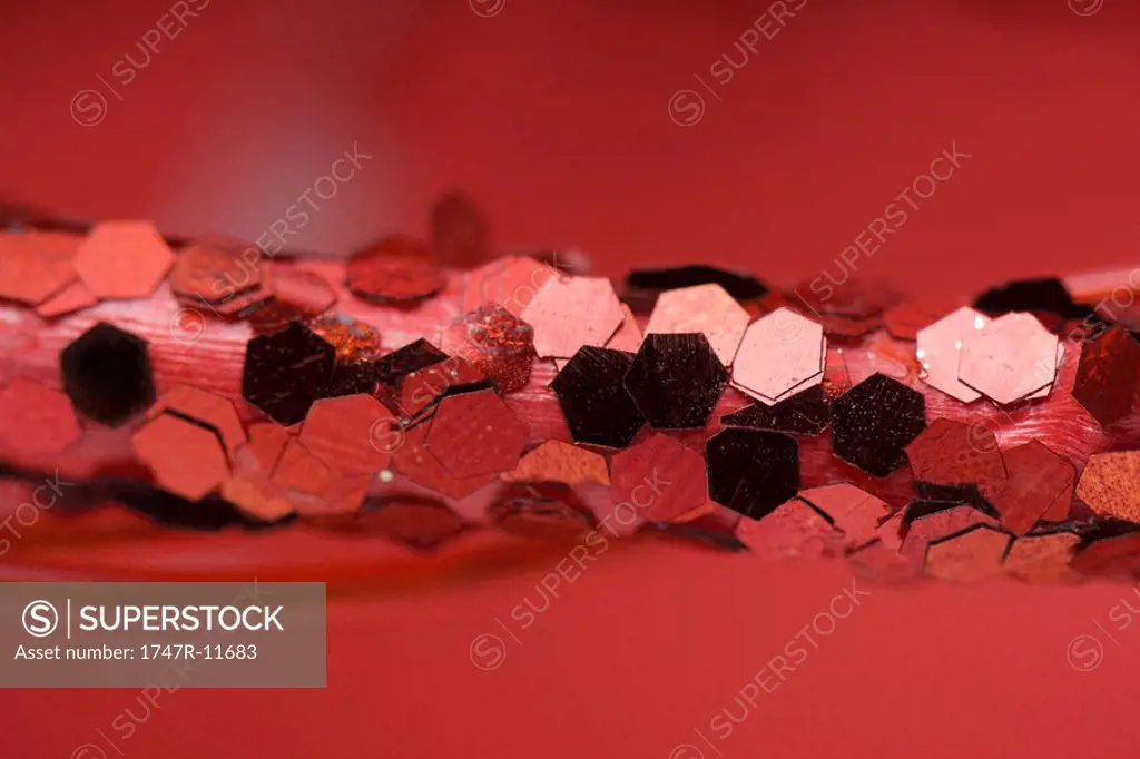 Christmas decoration covered in red sequins, extreme close-up