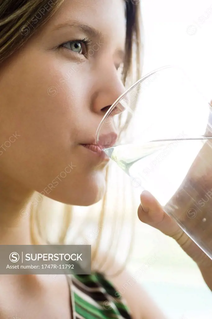 Young woman drinking glass of water