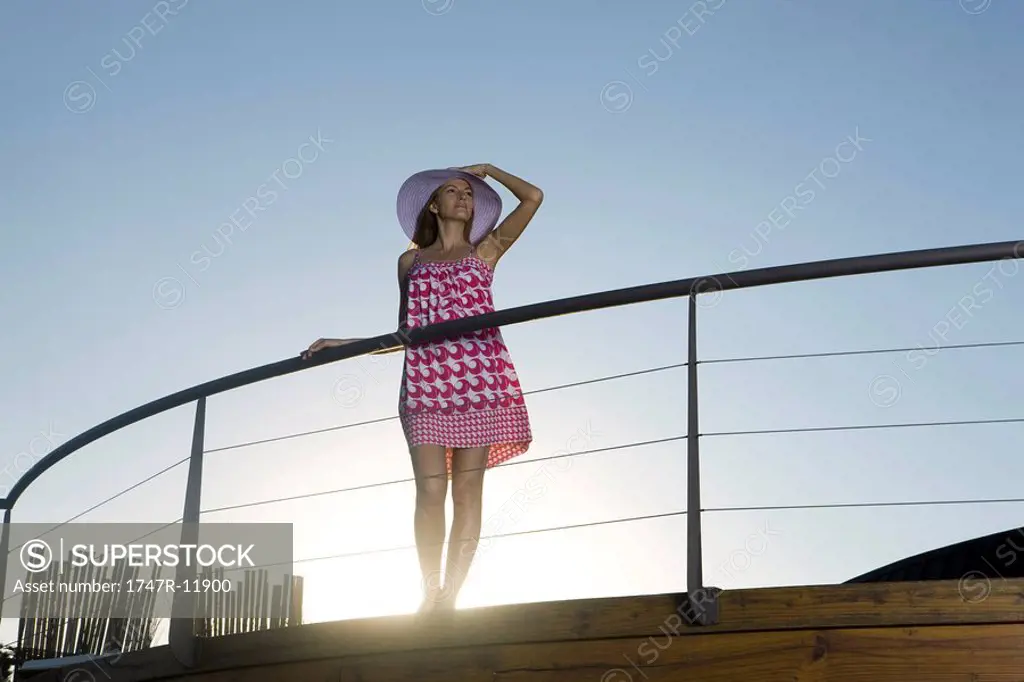 Woman standing on deck, looking at view