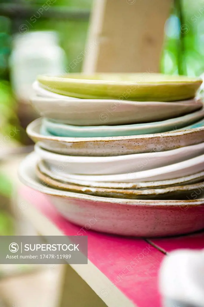 Plates stacked on shelf
