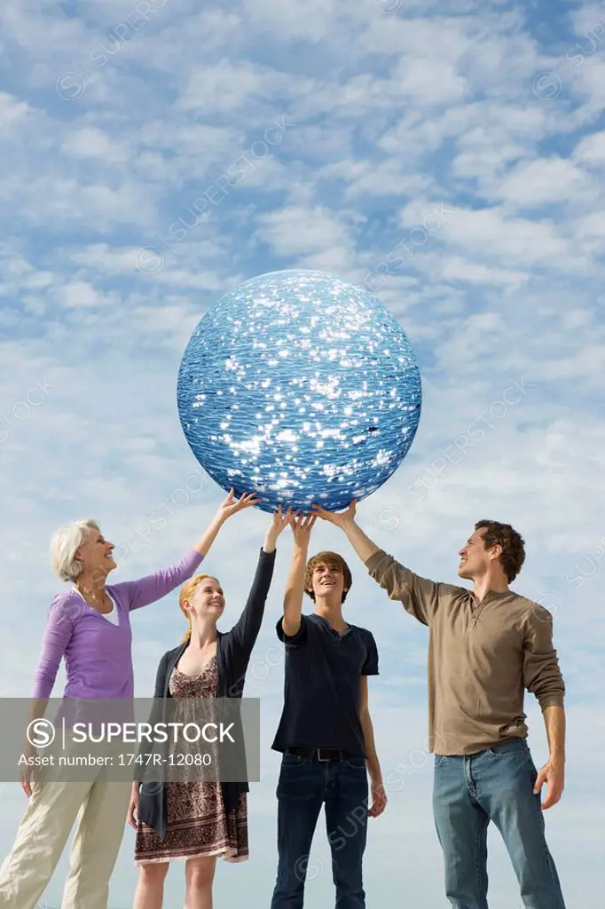 Ecology concept, people holding up planet of water