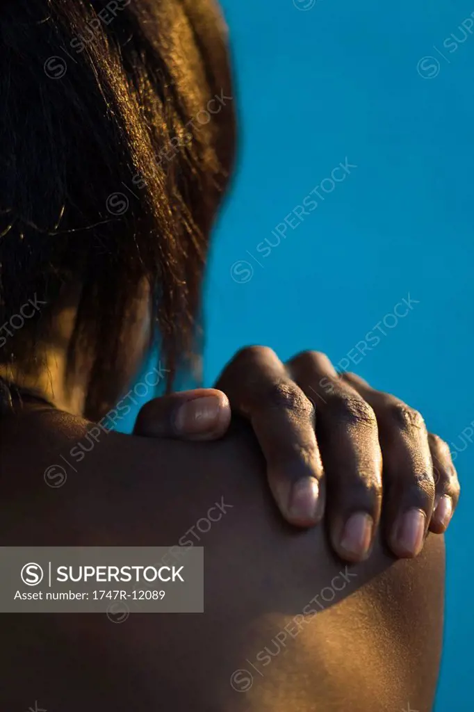 Woman´s hand on bare shoulder