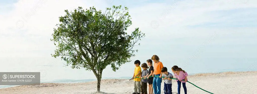 Ecology concept, children watering tree together