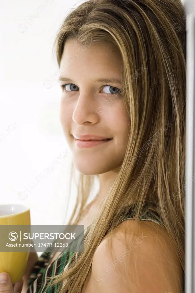 Young woman with cup of coffee, portrait