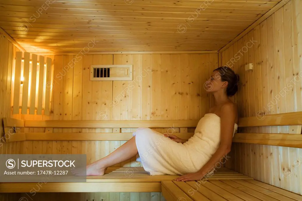 Woman relaxing in sauna