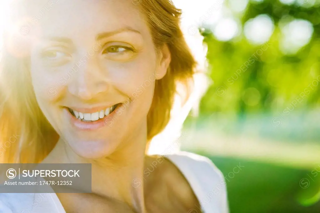 Young woman outdoors on sunny day, portrait
