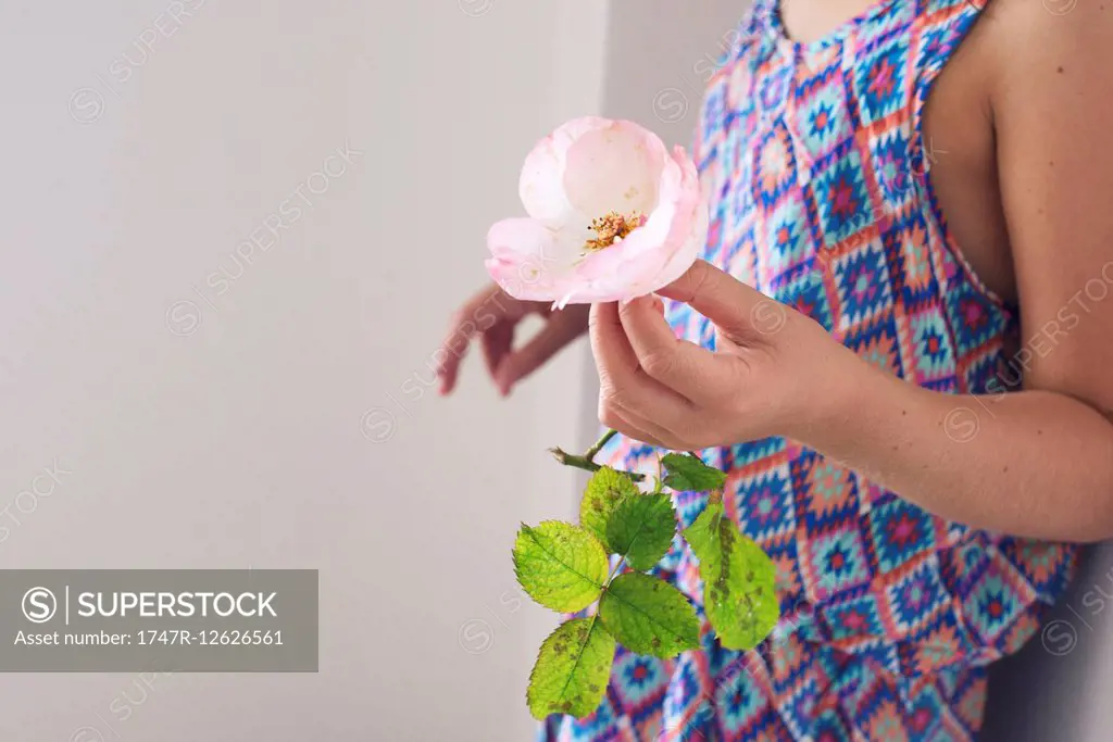Girl holding rose, cropped