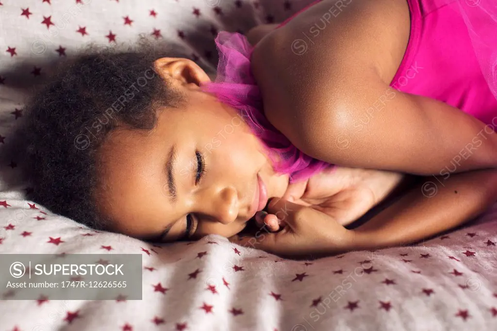 Little girl resting on bed