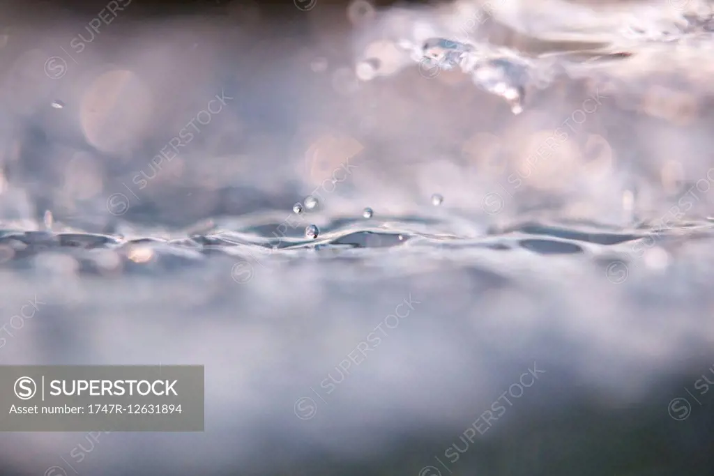 Close-up of drops splashing on water surface