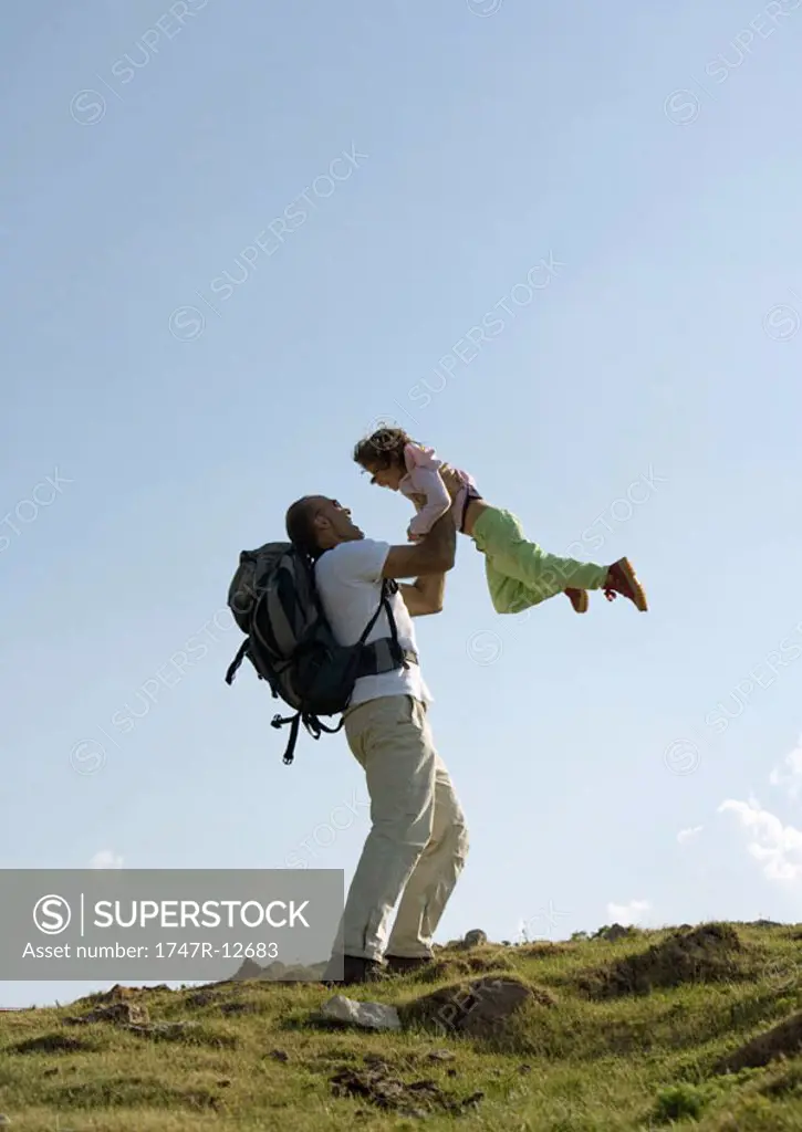 Hiker picking up daughter