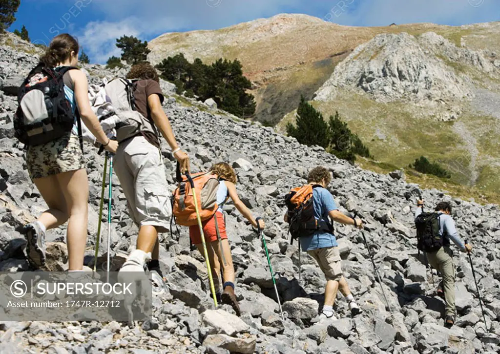 Hikers walking across rocky landscape