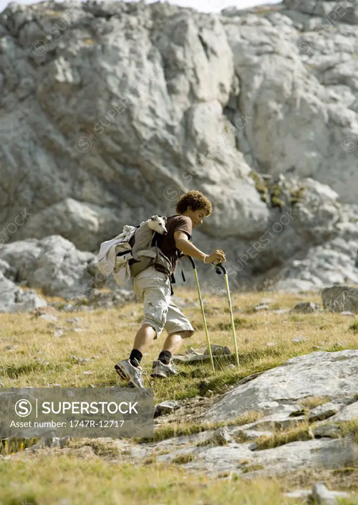 Hiker walking through rocky landscape