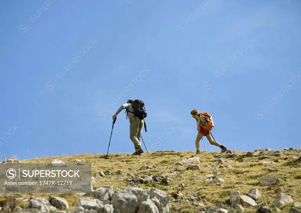 Hikers on mountainous landscape
