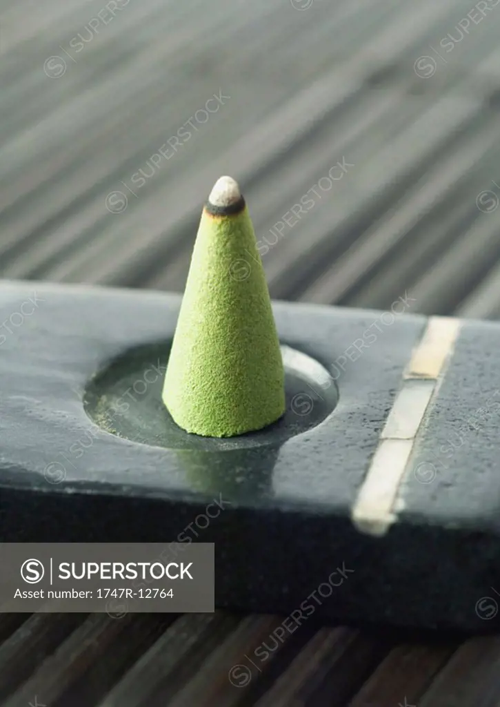 Incense cone burning in incense holder