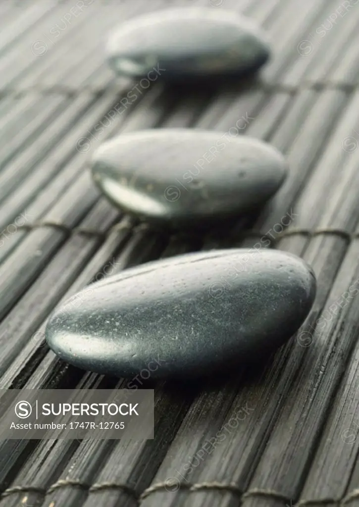 Three smooth black stones