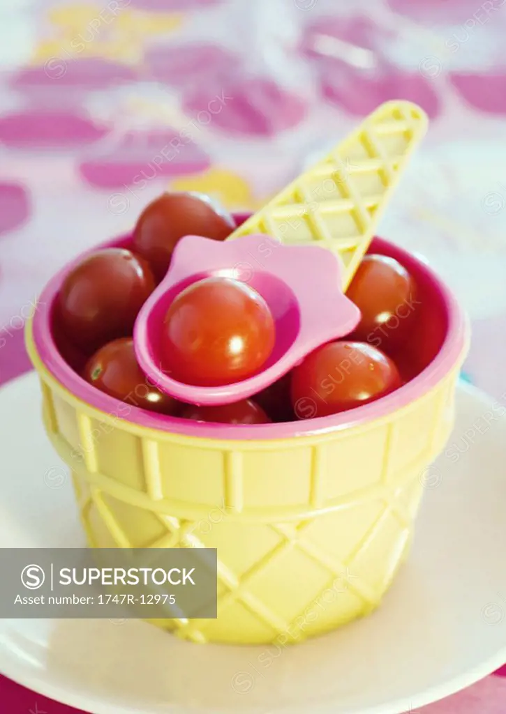 Ice cream cone shaped dish containing cherry tomatoes