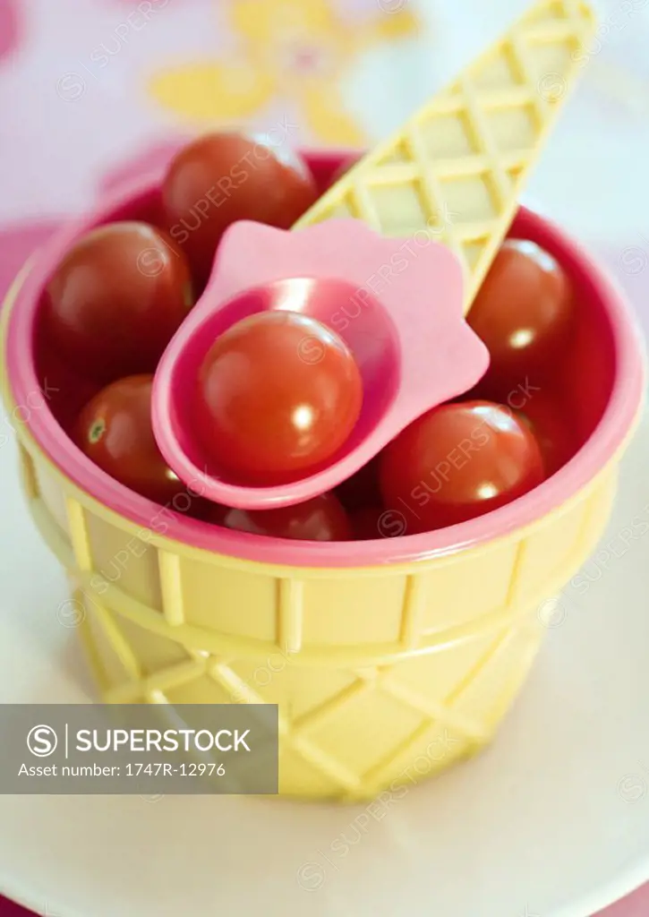 Ice cream cone shaped dish containing cherry tomatoes