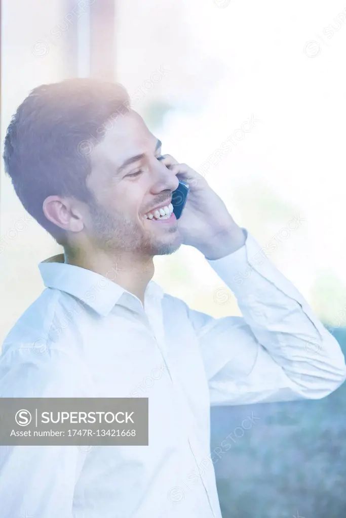 Businessman receiving good news phone call