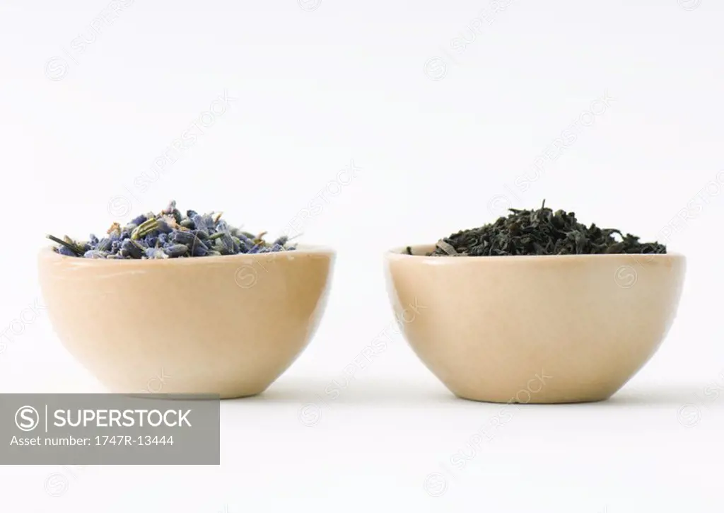 Dried lavender and tea leaves in bowls, side by side