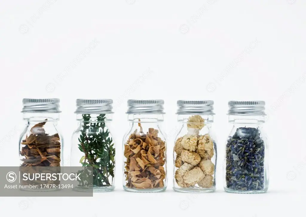Bottles of dried flowers, herbs and wood shavings