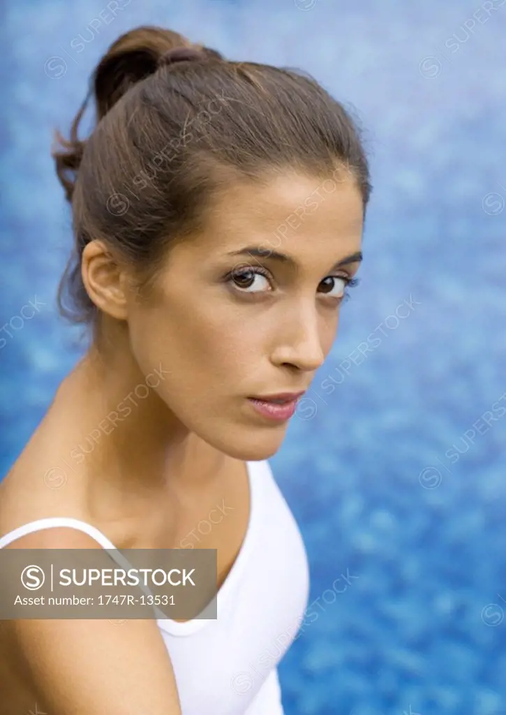 Young woman by poolside, portrait