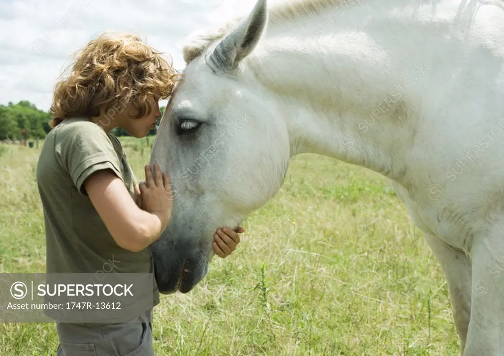Boy kissing horse