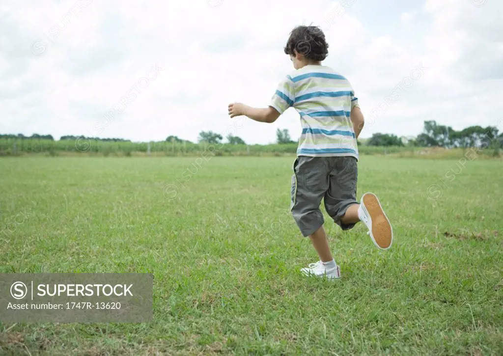 Boy running in field
