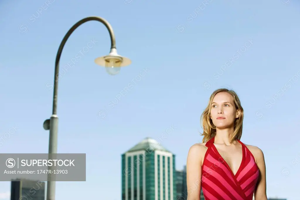 Woman in urban setting, looking away