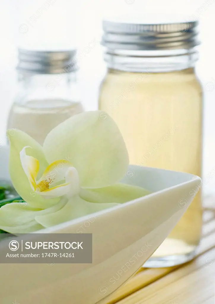 Orchid blossom and bottles of essential oils