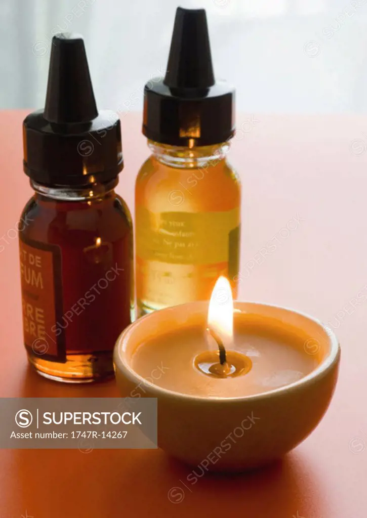Bottles of scented oils and candle