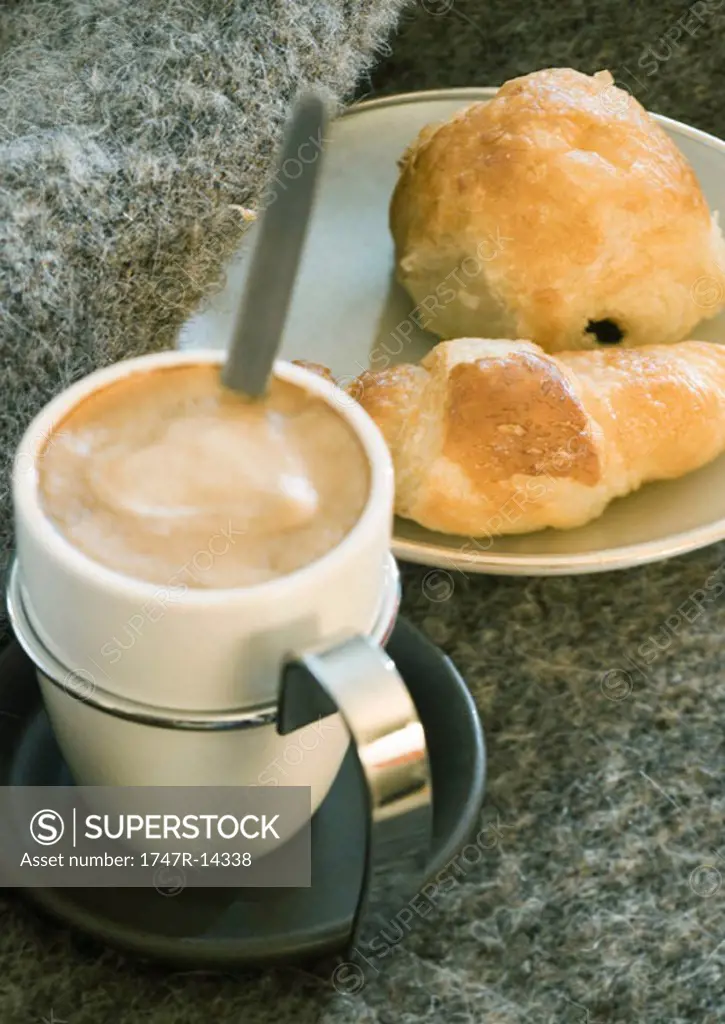 Cup of espresso and small pastries