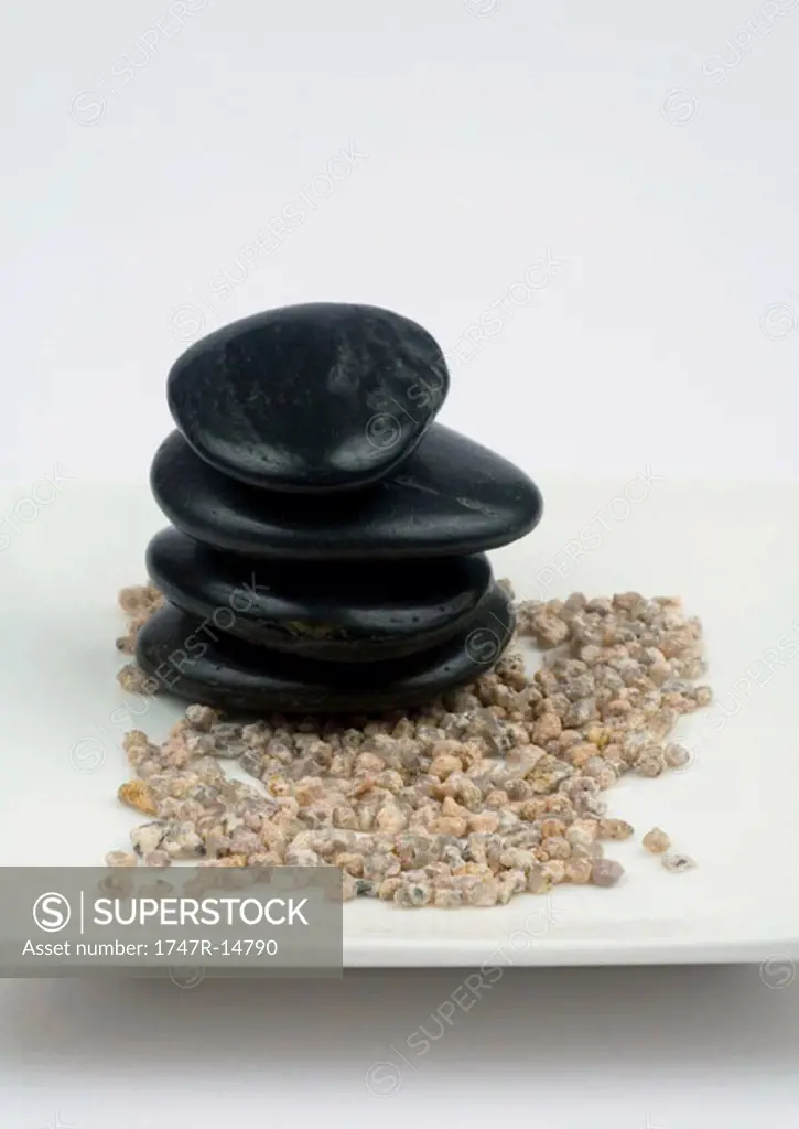 Stack of black stones on gravel