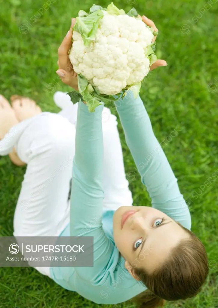 Woman holding up cauliflower