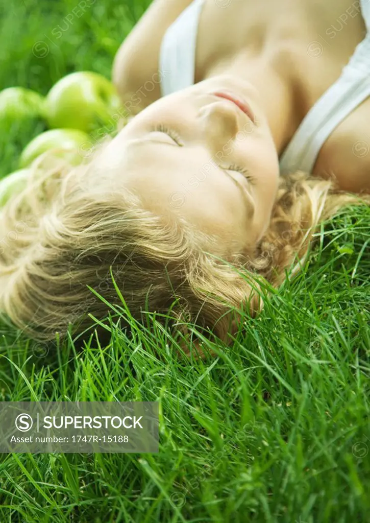 Woman lying in grass