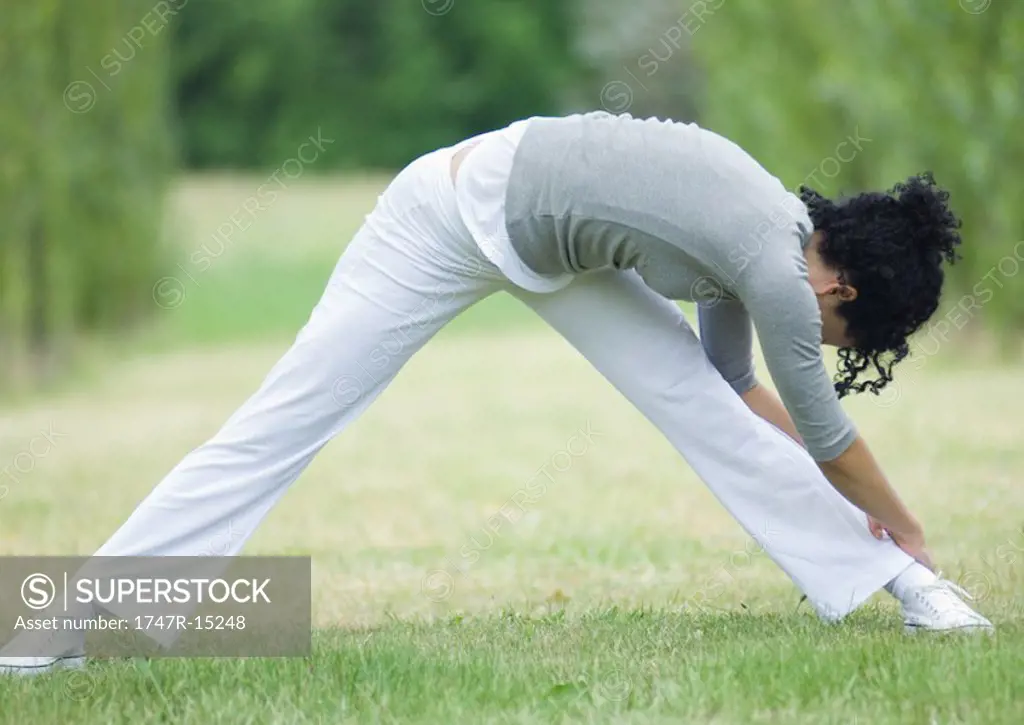 Young woman stretching, outdoors