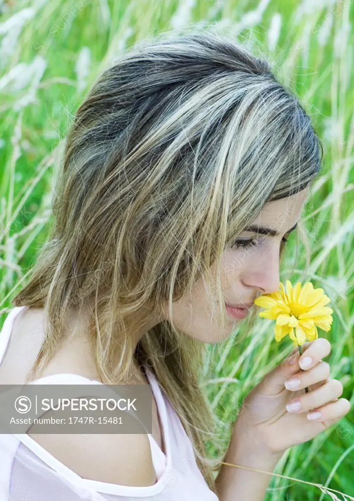 Woman smelling flower