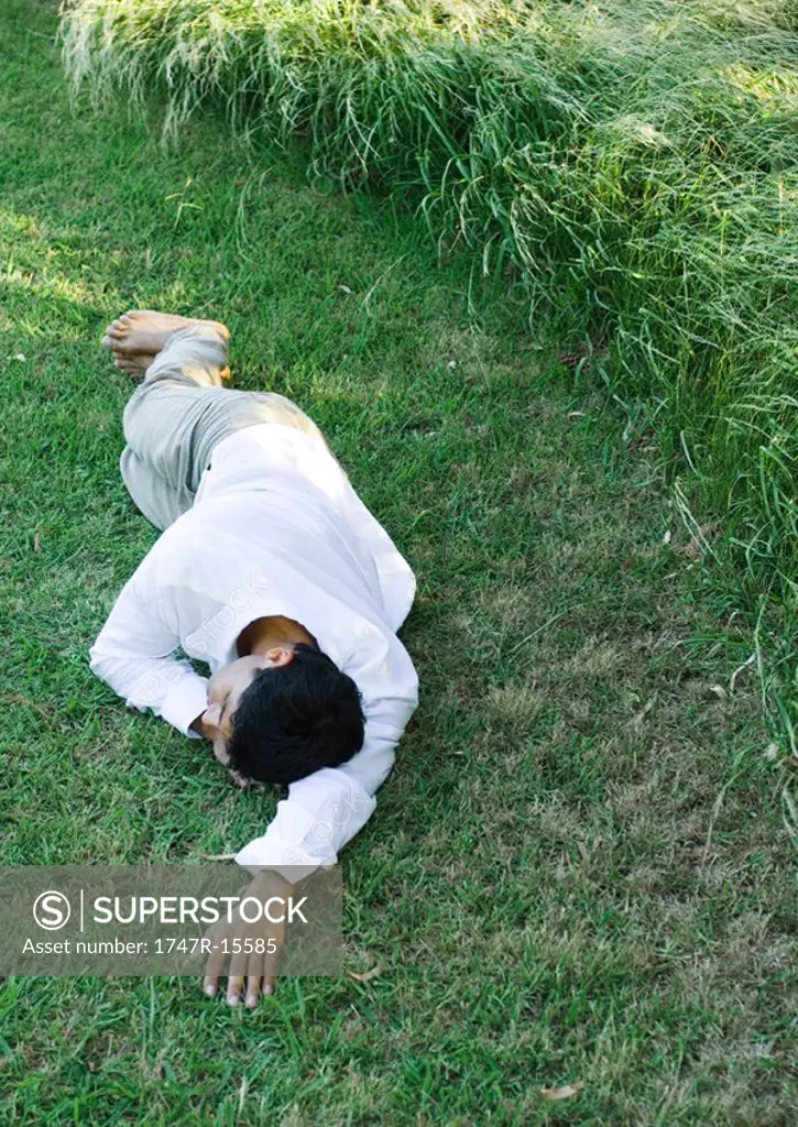 Man lying on grass, sleeping
