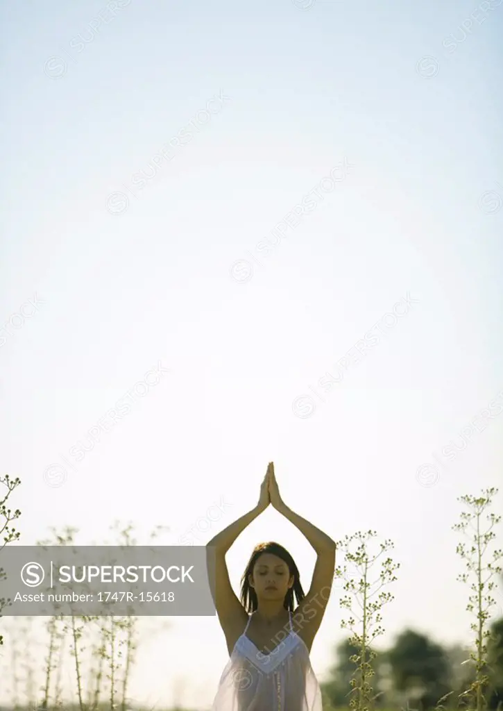 Woman standing in prayer position