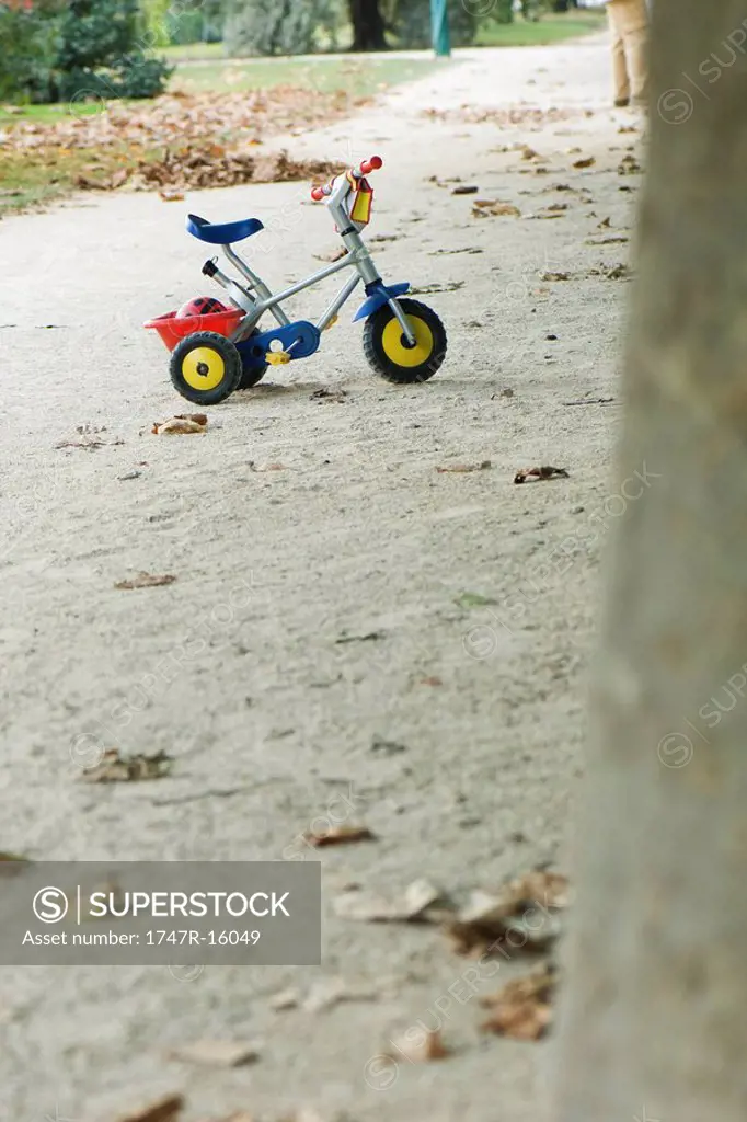 Child´s tricycle on gravel path