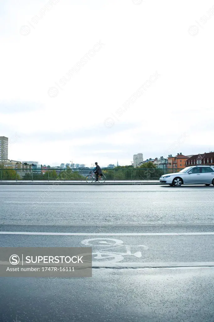 Sweden, Sodermanland, Stockholm, cyclist and car sharing road