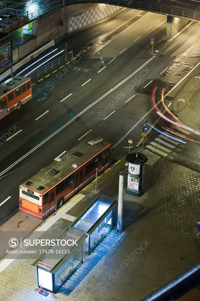 Sweden, Stockholm, bus waiting by bus stop at night, high angle view