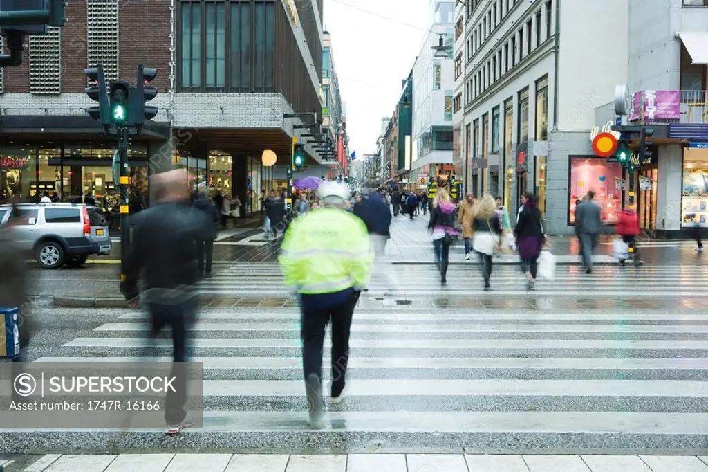 Sweden, Stockholm, pedestrians crossing street