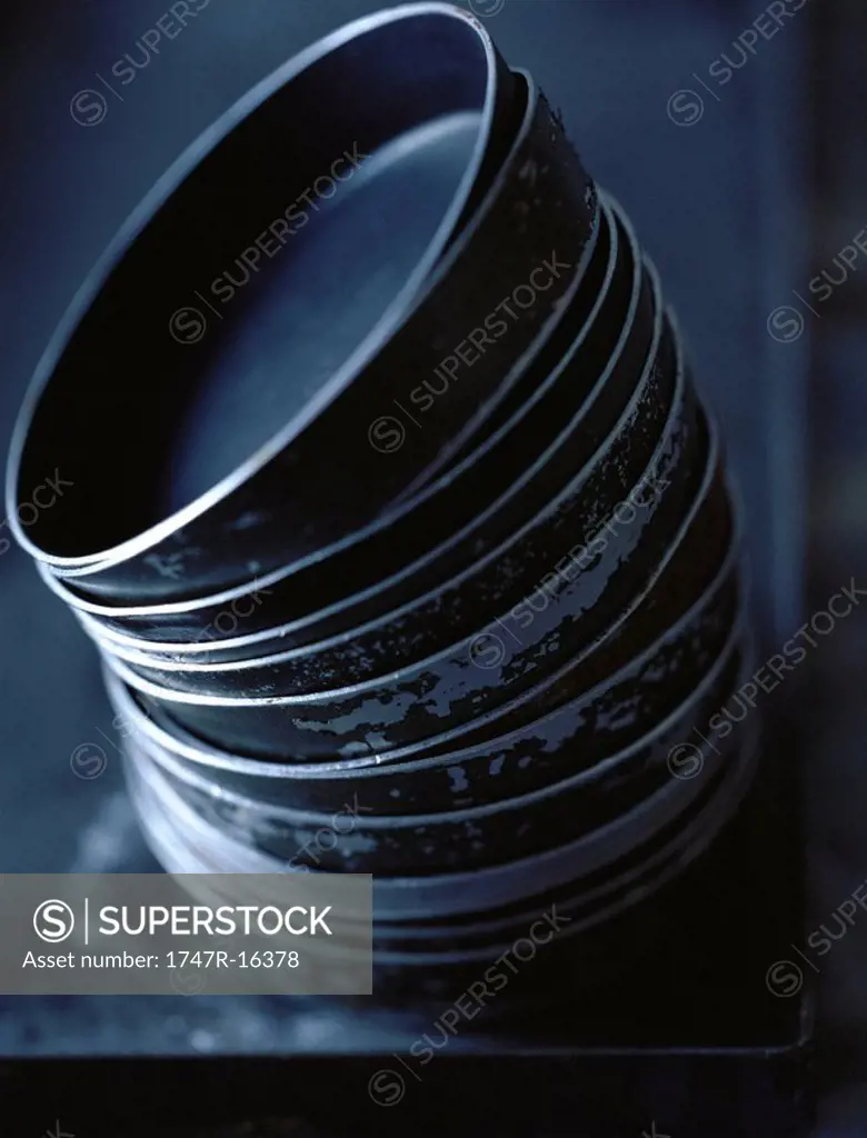 Leaning stack of baking pans